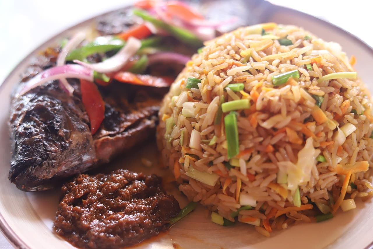 A plate of jollof rice with chicken and vegetables